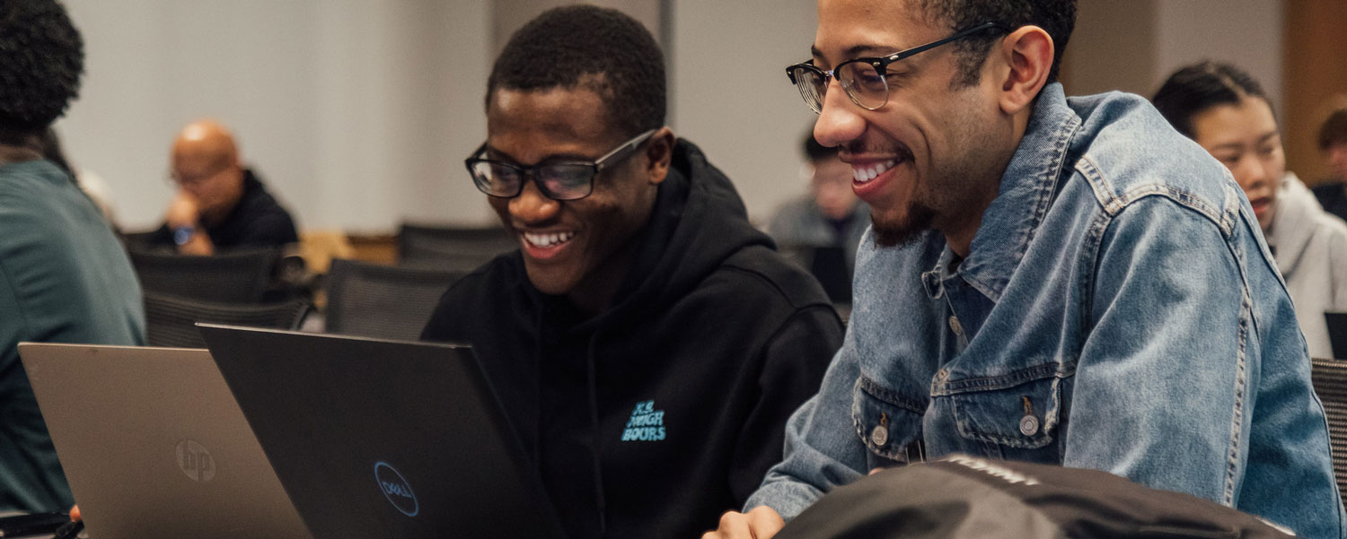 Students working at a laptop